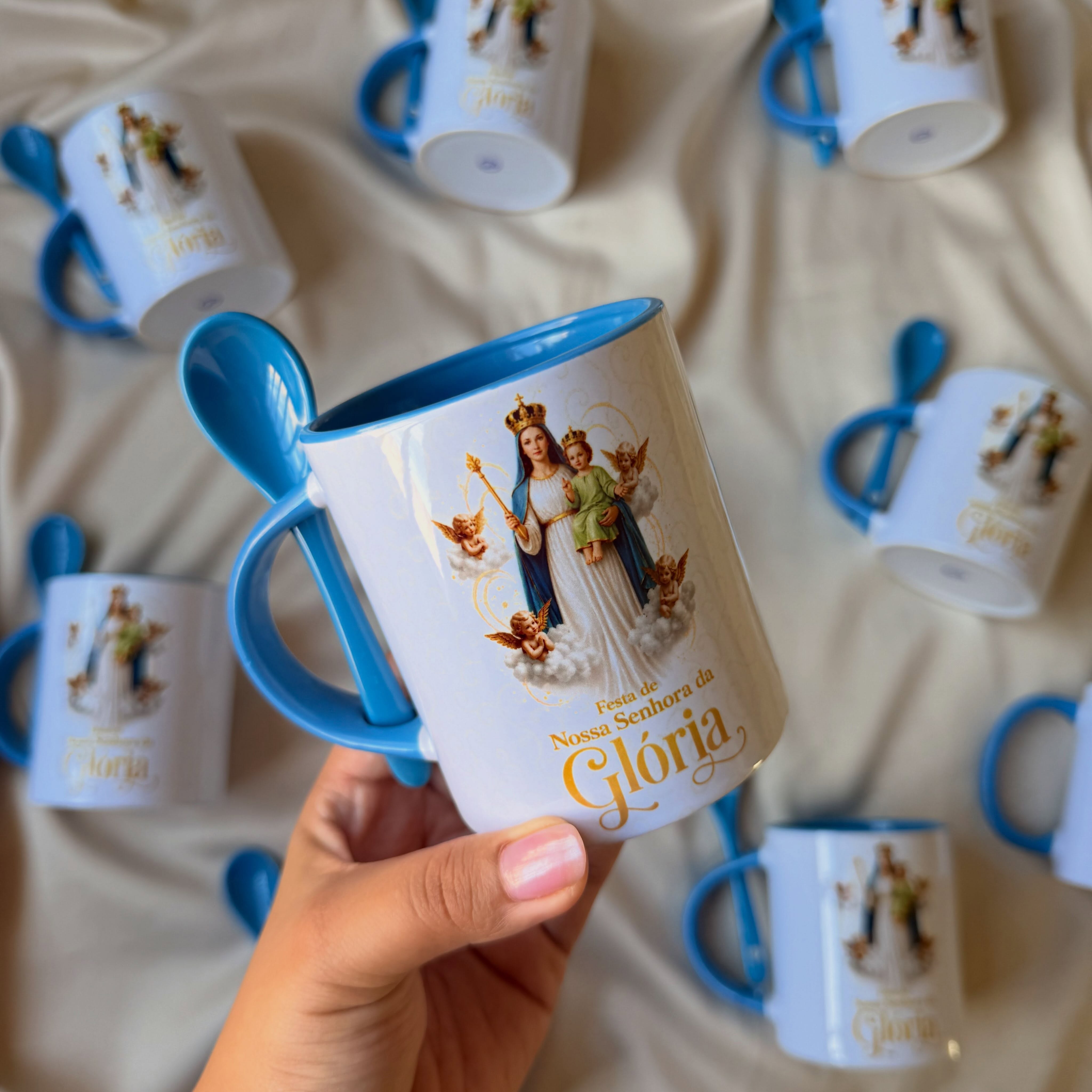 Canecas de Nossa Senhora da Glória com alças azuis, produzidas pela Lopes e Oliveira